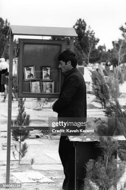Relative of a soldier killed in the Iran-Iraq war stands at his grave on Norouz in Behesht Zahra cemetery, Tehran, Iran, 21st March 1981.