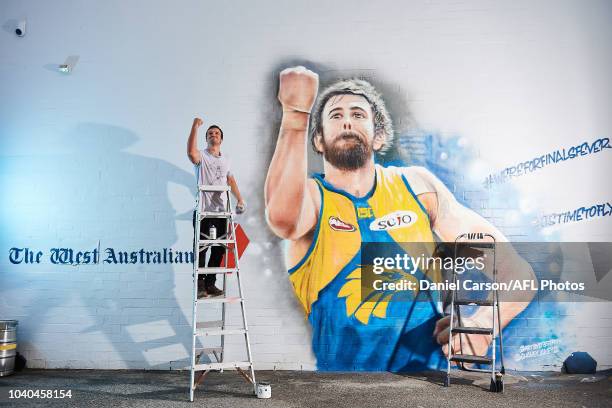 One of the two artists Jacob Butler poses in front his Josh Kennedy 2018 Mural commissioned by Seven West Media and the West Australian Newspaper in...