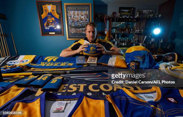 West Coast Eagles fan Brad Kent shows off his collection of merchandise on Brad's Eagles themed pool table on September 25, 2018 in Perth, Australia.
