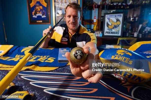 West Coast Eagles fan Brad Kent shows off the 8 Ball and his collection of merchandise on Brad's Eagles themed pool table on September 25, 2018 in...