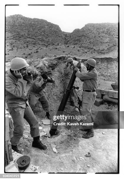 Iranian soldiers prepare a mortar launch onto Iraqi soil on the Allah Akbar front, near Ahwaz, Iran, during the Iran-Iraq War, 9th December 1980.