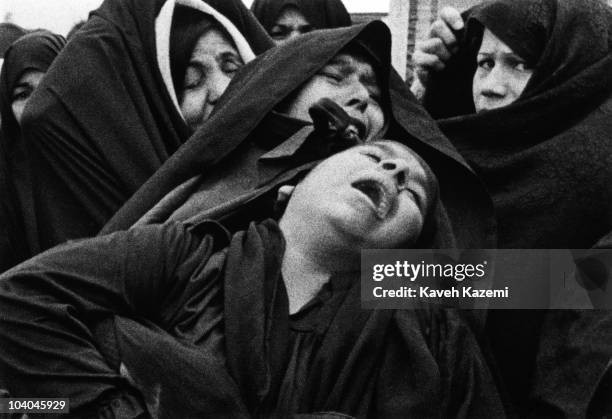 Female relatives of an air raid victim mourn his death on Norouz at Behesht Zahra cemetery, Tehran, Iran, during the Iran-Iraq War, 21st March 1981.
