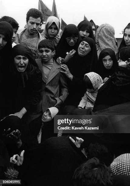 Relatives of an air raid victim mourn his death on Norouz at Behesht Zahra cemetery, Tehran, Iran, during the Iran-Iraq War, 21st March 1981.
