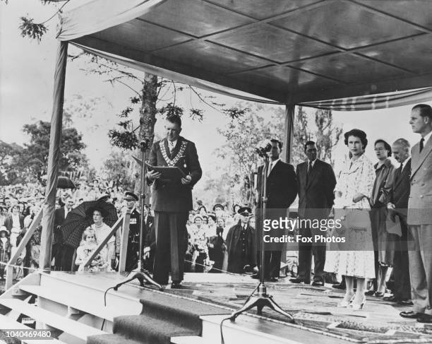 The Mayor of Casino, Richmond Manyweathers reads an address of welcome to Queen Elizabeth II at Carrington Park, Casino, New South Wales, Australia,...