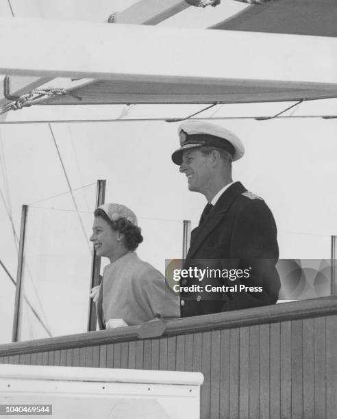 Queen Elizabeth II and Prince Philip on the bridge of the SS Gothic as they leave Bluff Harbour, New Zealand, on their way to Australia, during the...