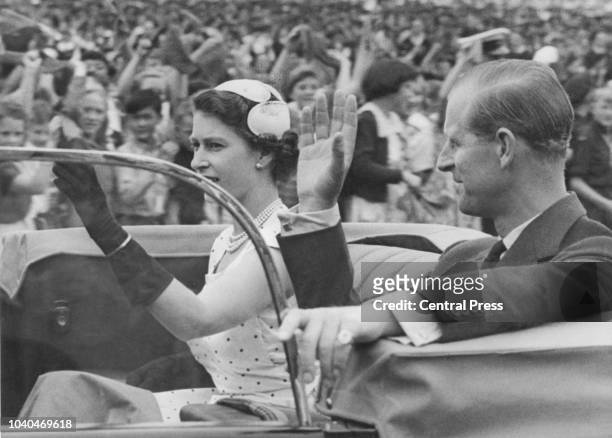 Queen Elizabeth II and Prince Philip returning to Government House after attending a youth rally in Auckland Domain, in Auckland, New Zealand, during...