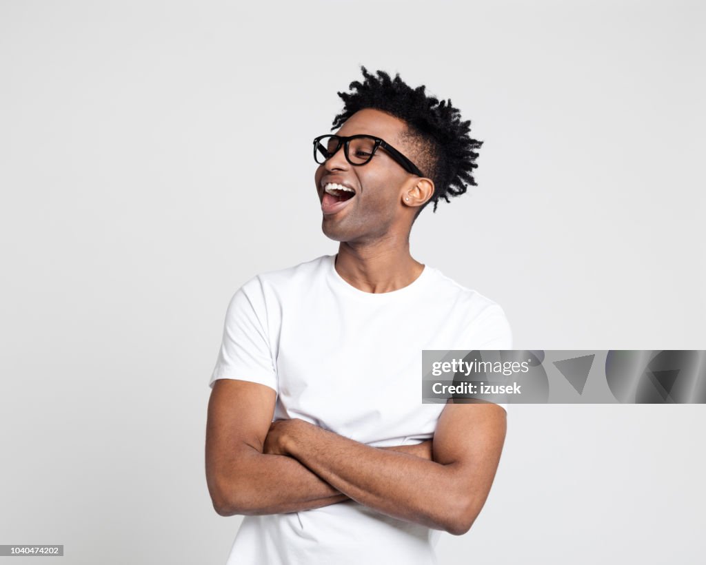 African man looking at copy space and laughing
