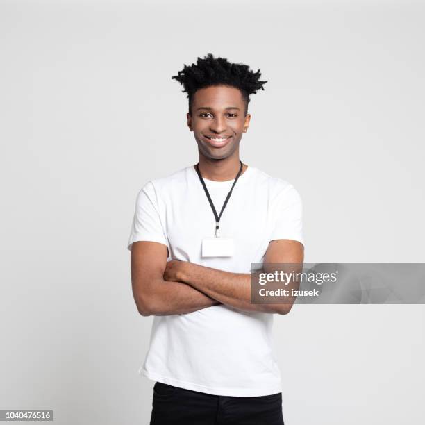 young black employee wearing a badge - employee badge stock pictures, royalty-free photos & images