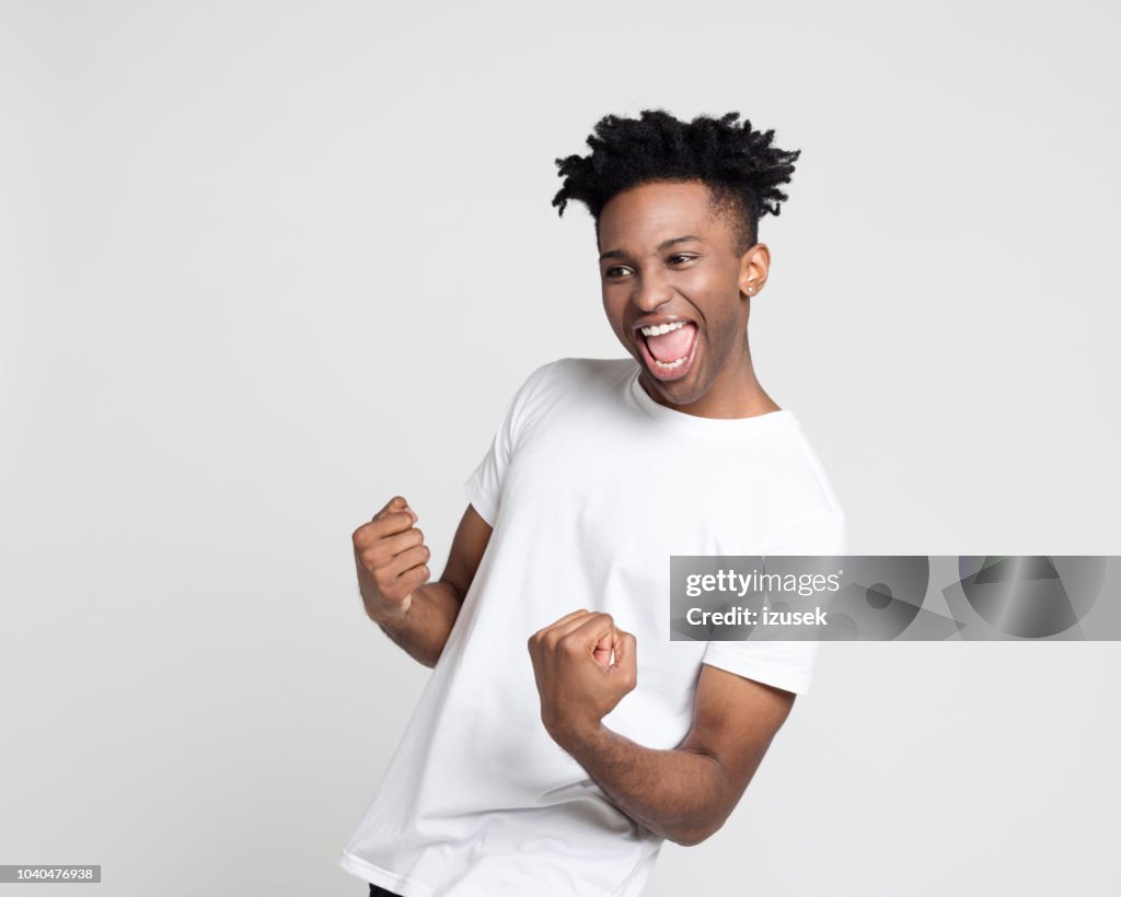 Excited young guy celebrating success