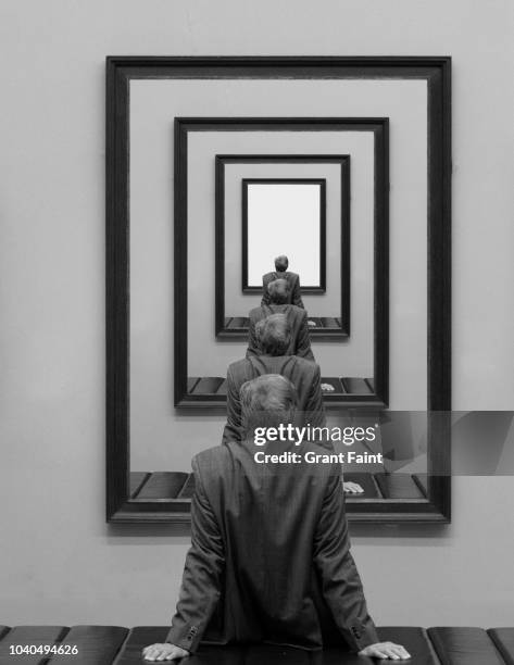 man looking into picture frame. - contemplation concept fotografías e imágenes de stock