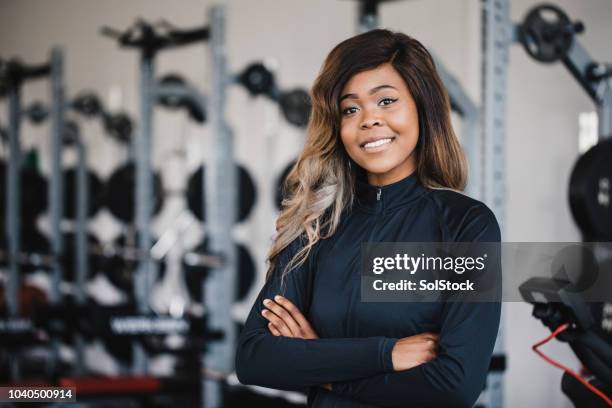 portrait of a female personal trainer in the gym - sport coach united kingdom stock pictures, royalty-free photos & images