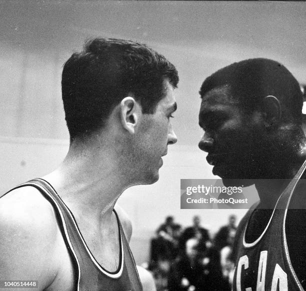 View of American basketball players Bill Bradley and Jim Barnes as they face one another during the elimination tournament game for selection of the...
