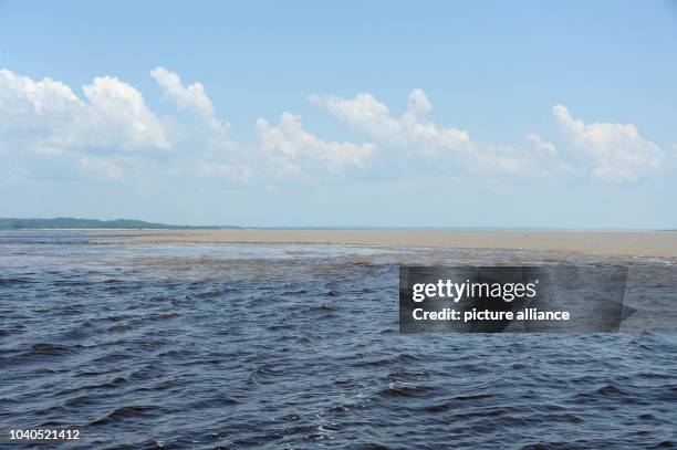 View of the confluence of the Solimões, the upper stretch of the Amazon River, and the Rio Negro near Manaus, Brazil, 11 December 2013. Photo: MARCUS...