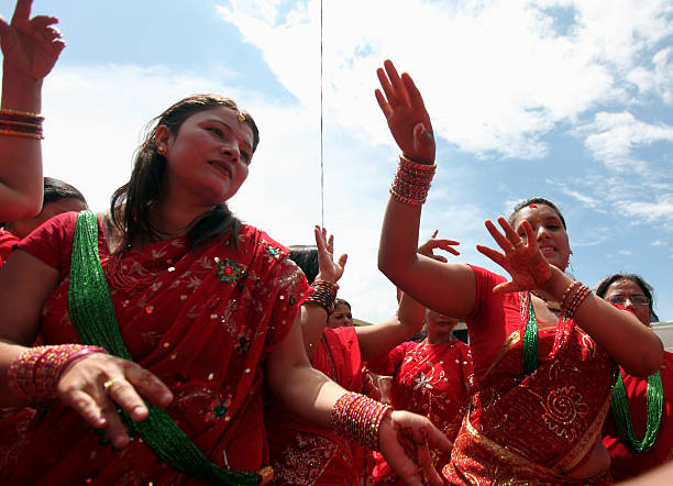 Nepalese Hindus dressed in red dance after paying homage to Shiva, the Hindu god of destruction, as they celebrate the Teej festival in Kathmandu on...