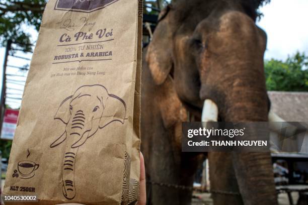 This photo taken on September 1, 2018 shows a pack of coffee produced by a family locally known as "the king of elephants" being sold at a tourist...