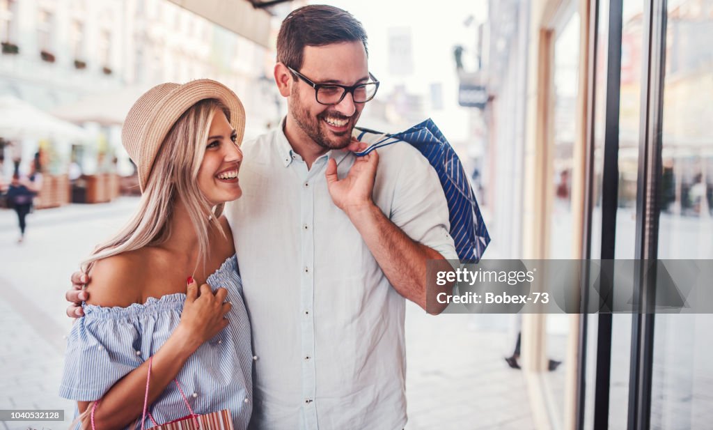 Shopping time. Young couple in shopping. Consumerism, love, dating, lifestyle concept