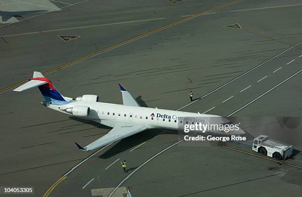 Delta Airlines regional jet aircraft is towed to a Vancouver International Airport gate on July 7, 2010 in Vancouver, British Columbia, Canada....