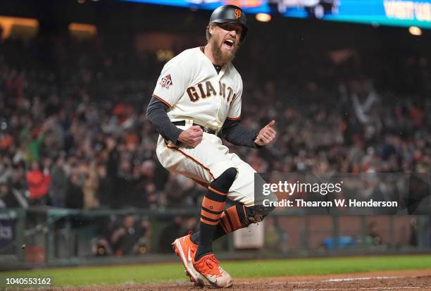 Hunter Pence of the San Francisco Giants reacts after he scored against the San Diego Padres in the bottom of the seventh inning at AT&T Park on...