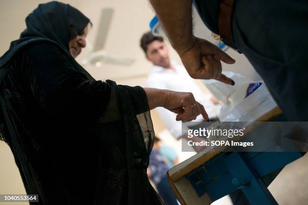 Woman seen dipping her finger in indelible ink after voting in the Kurdish independence referendum. The central government in Baghdad closed...