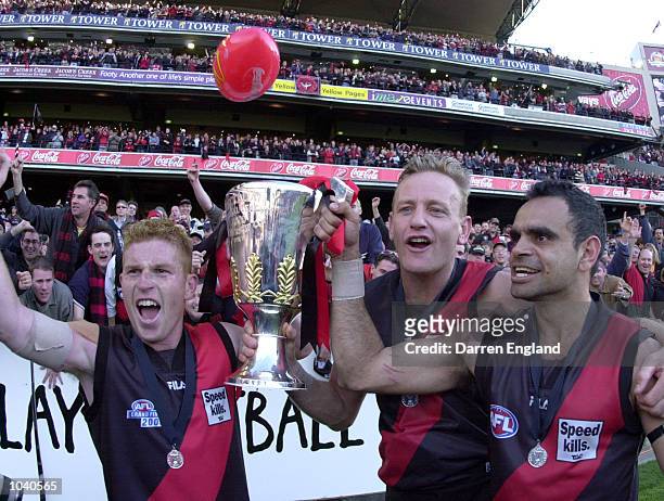 Gary Moorcroft, John Barnes and Michael Long of Essendon celebrate after winning the 2000 AFL Grand Final match between Essendon Bombers v Melbourne...
