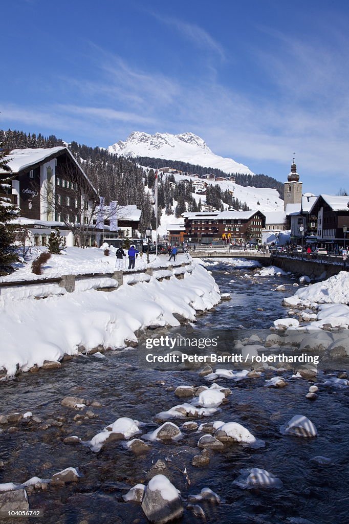 River and village church Lech, near St. Anton am Arlberg in winter snow, Austrian Alps, Austria, Europe