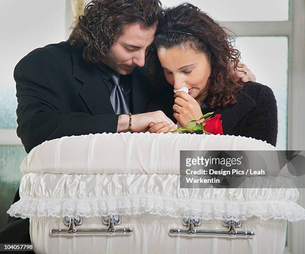 grieving couple with infant's coffin - mourning stock pictures, royalty-free photos & images