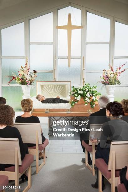 the deceased laying in a coffin at his funeral - coffin stock pictures, royalty-free photos & images