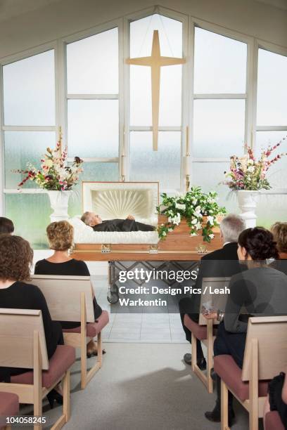 the deceased laying in a coffin at his funeral - cadaver stock pictures, royalty-free photos & images