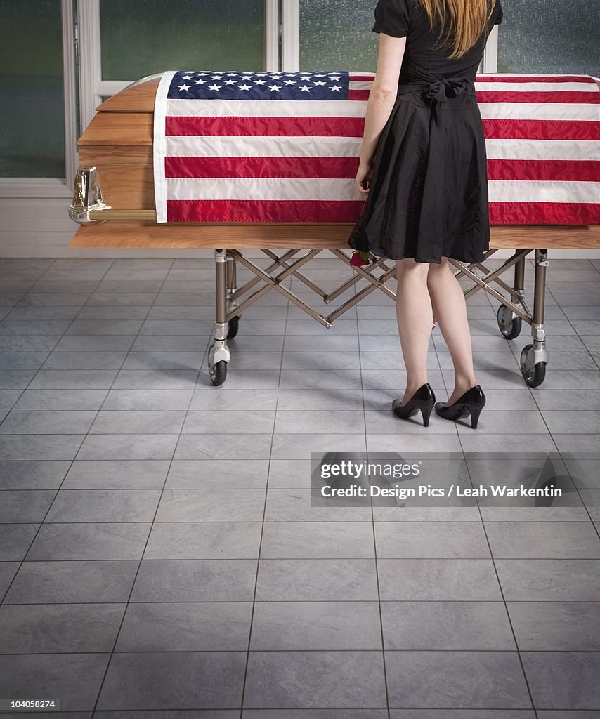 Paying Respects To The Deceased With An American Flag Draped Over The Coffin