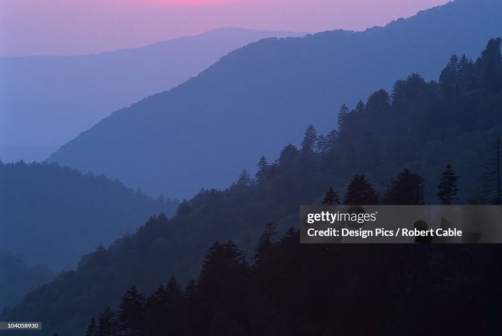Sunset Light Filtering Through Misty Mountain Ridges At The Great Smoky Mountains National Park