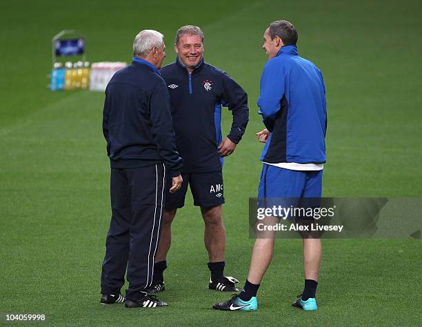 Walter Smith the manager of Rangers talks with Ally McCoist and David Weir during a training session at Old Trafford on September 13, 2010 in...