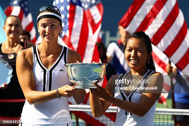 Vania King of the United States and Yaroslava Shvedova of Kazikstan celebrate with their throphy after defeating Liezel Huber and Nadia Petrova of...