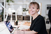 Portrait of graphic designer in Scandinavia, working on laptop.