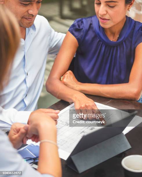 couple having a business meeting with a architect or real estate agent. - home renovations australia stock pictures, royalty-free photos & images