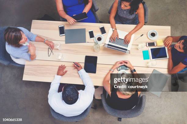 business meeting shot from above. - conference table stock pictures, royalty-free photos & images