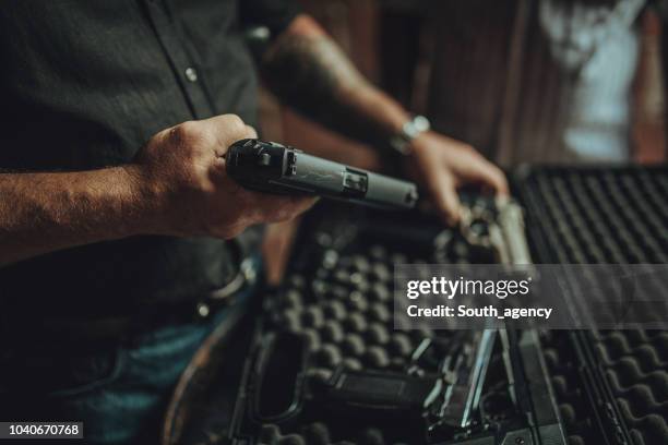 buying a gun on black market - revólver imagens e fotografias de stock