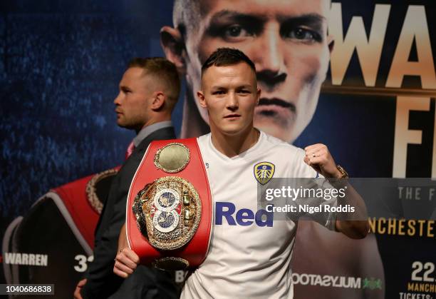 Josh Warrington poses for a picture as Carl Frampton walks past a press conference for the Josh Warrington and Carl Frampton Media Tour on September...