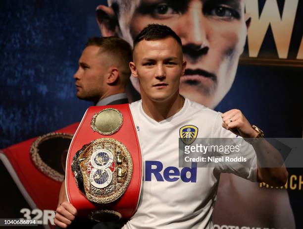 Josh Warrington poses for a picture as Carl Frampton walks past a press conference for the Josh Warrington and Carl Frampton Media Tour on September...
