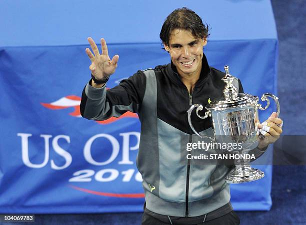 Rafael Nadal of Spain holds the championship trophy as he celebrates his 6-4, 5-7, 6-4, 6-2 win over Novak Djokovic of Serbia in the Men's Finals at...