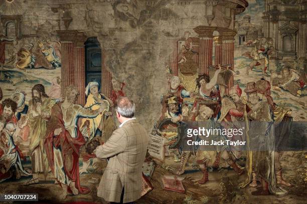 Former director of the Metropolitan Museum of Art Thomas Campbell inspects a 16th Century tapestry depicting St Paul burning heathen books in the...