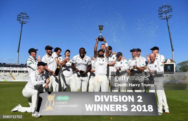 Jeetan Patel of Warwickshire lifts the trophy as his sides are named Champions of Division Two during Day Three of the Specsavers County Championship...