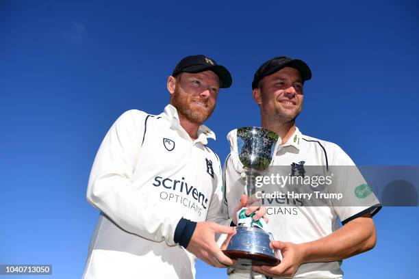 Ian Bell and Jonathan Trott of Warwickshire pose with the trophy after winning Division Two during Day Three of the Specsavers County Championship...