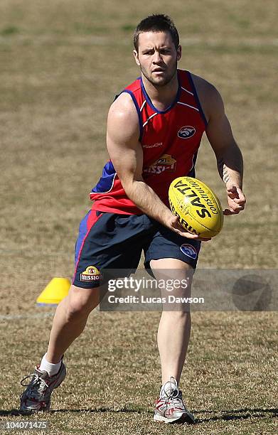 Andrew Hooper of the Bulldogs handballs the ball during a Western Bulldogs AFL training session at Whitten Oval on September 14, 2010 in Melbourne,...