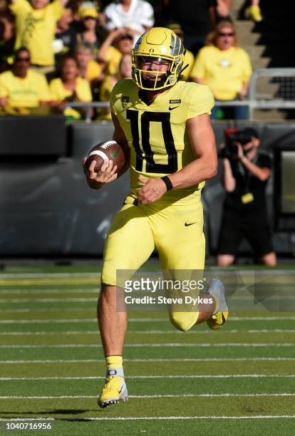 Justin Herbert of the Oregon Ducks runs with the ball during the first half of the game against Bowling Green Falcons at Autzen Stadium on September...