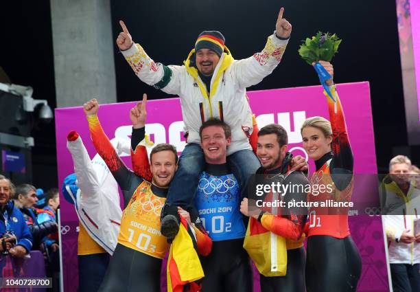 Tobias Arlt , Felix Loch, Tobias Wendl and Natalie Geisenberger of Germany celebrate with former luger Georg Hackl of Germany after winning the gold...