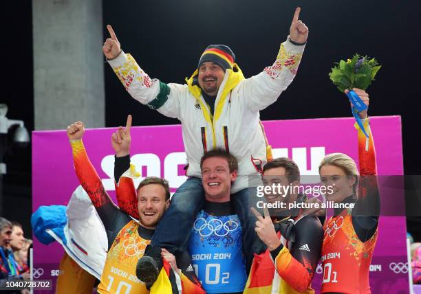 Tobias Arlt , Felix Loch, Tobias Wendl and Natalie Geisenberger of Germany celebrate with former luger Georg Hackl of Germany after winning the gold...