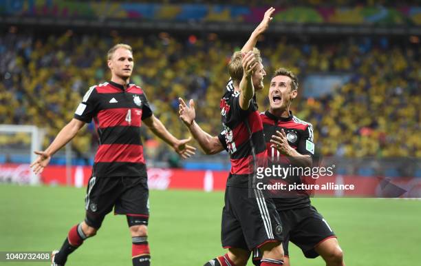 Toni Kroos of Germany celebrates with his teammmates Miroslav Klose and Benedikt Hoewedes after scoring 0-3 goal during the FIFA World Cup 2014...