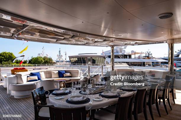 Dining table sits on a deck of luxury superyacht Excellence V, manufactured by Abeking & Rasmussen, during the Monaco Yacht Show in Port Hercules,...