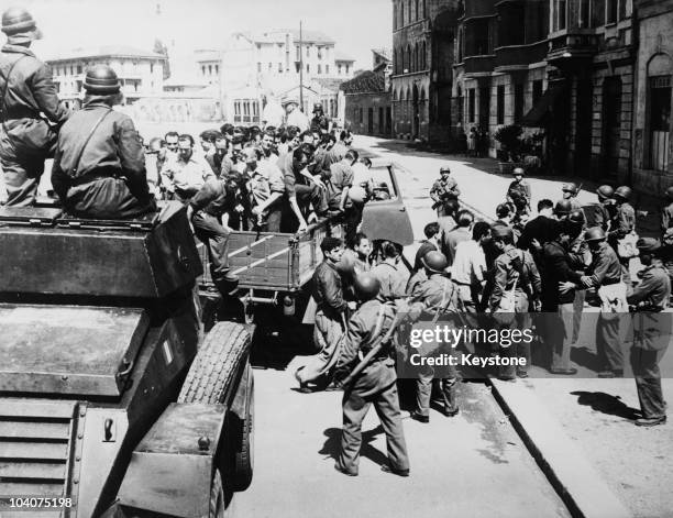 Italian police stop a truck carrying communist flying picketers during a national general strike, Italy, 19th July 1948. The strike has been called...