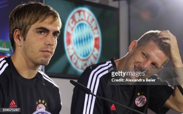 Bastian Schweinsteiger and Philipp Lahm of Bayern Muenchen answer journalists questions during a news conference ahead of the Champions League first...